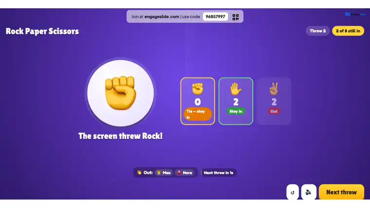 Rock Paper Scissors finale duel tie-breaker på EngageSlide storskærmen: Maya og Ben plukke på deres telefoner, skærmen sanger og Maya vinder kastet